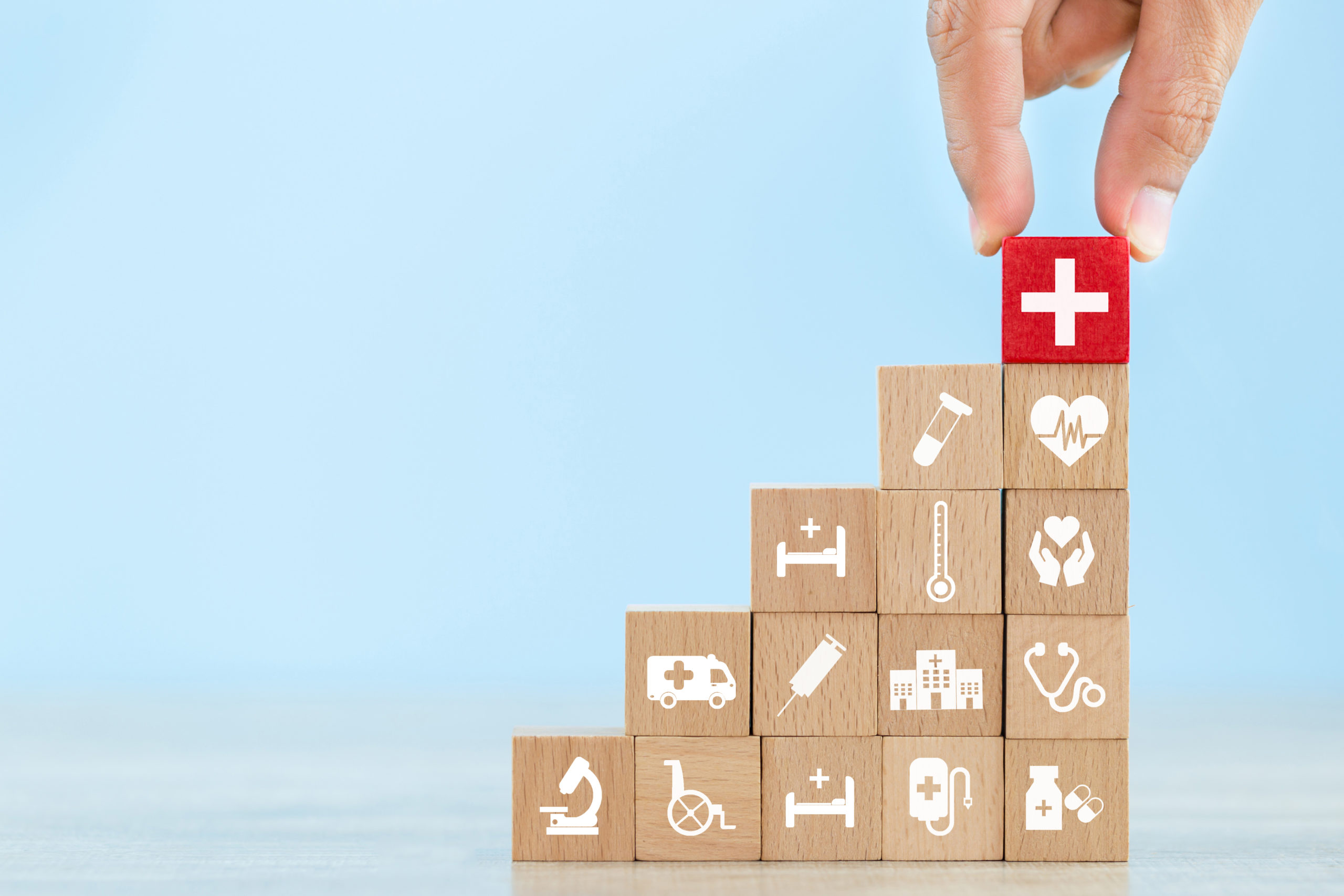 health insurance concept,hand arranging wood block stacking with icon healthcare medical.